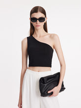 A lady wears sunglasses and a crop top.